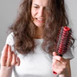 A lady worried about how to stop hair loss after perm